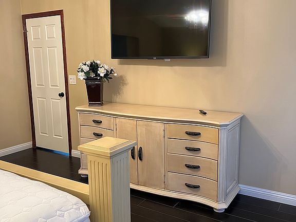 Primary bedroom features a 55" wall mounted television