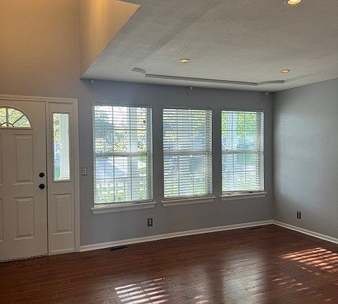 Living room just inside the front door. Stairs up to bedrooms. Stairs down to fireplace room. Kitchen on this same level.