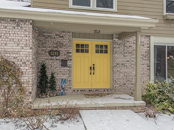 Welcoming front porch with freshly painted new front doors.