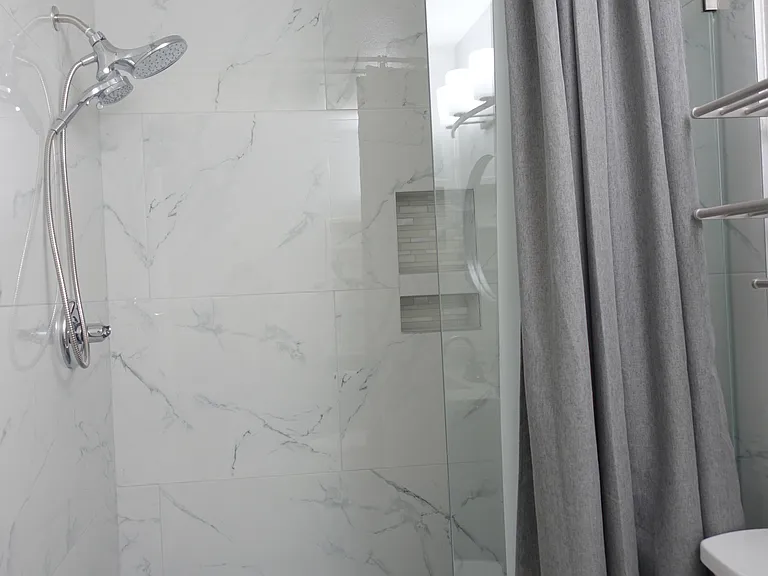 Bathroom #1: Large open shower with floor to ceiling marble tiles. Oversized shower head and detachable sprayer