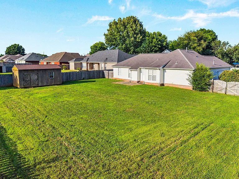 Large backyard with storage shed.