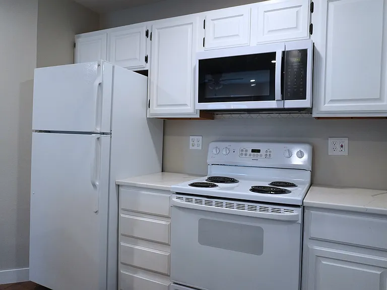 Fully equipped kitchen featuring a microwave, oven, and refrigerator_everything you need for cooking and meal prep.