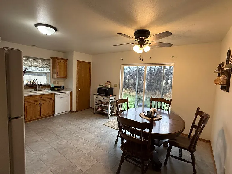 full size kitchen with 2 closets for storage, refrigerator, stove, and dishwasher, patio door going out to fenced area