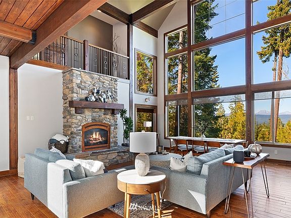 The heart of the home, enjoying views of the mountains by the stone fireplace in the great room.