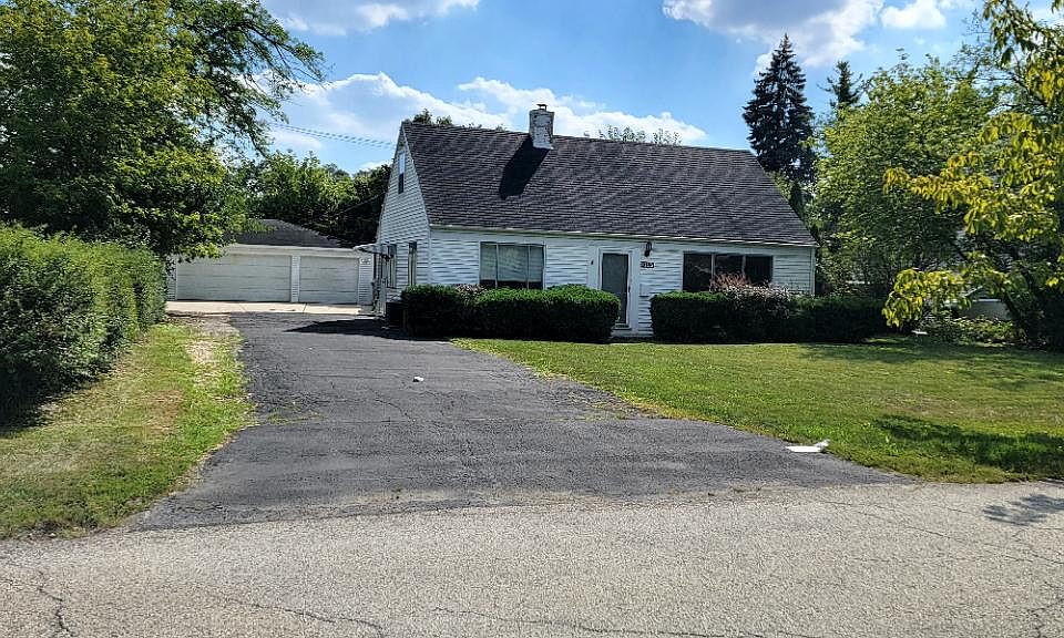 Front view of home with large driveway