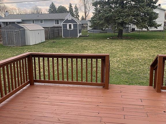 large deck overlooking fenced in back yard