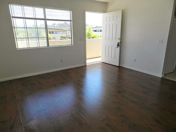 Dark laminate floors in main living areas, dual pane windows, natural light.