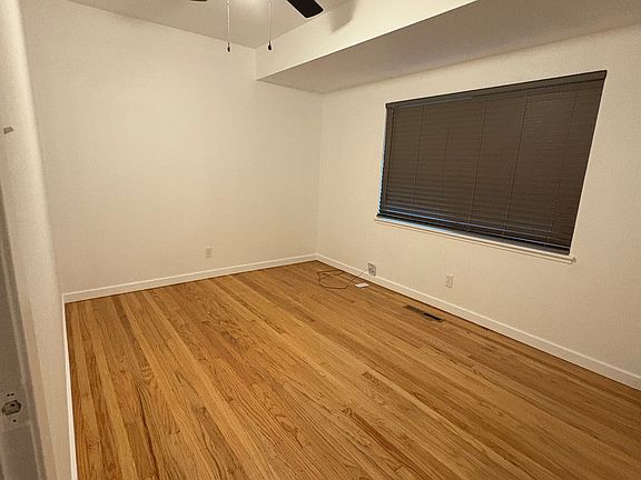 All three bedrooms have refinished hardwood floors, ceiling fans, and new paint.