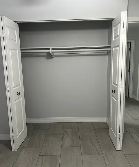 Second Floor Third (3) Bedroom, Brand New Tile and Grout, New Baseboard Molding, New Curtains, Ceiling Fan with Light, Large Wall Closet with New Hardware.