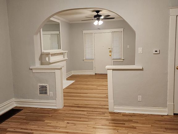 Another view of the front two rooms with new modern ceiling fixtures and canned lights in the middle room