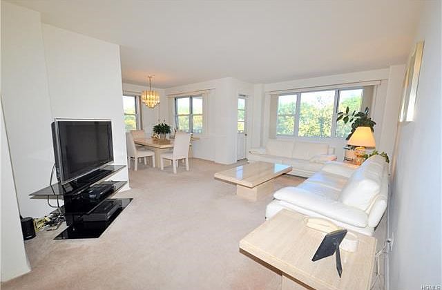 Bight and airy living room has sunny Eastern exposures.  The room has a door leading to a private balcony, great for enjoying the outdoors, and covered parquet floors.  The living room also open to a large entry foyer.  The living room is 20'-0" x 12'-0",