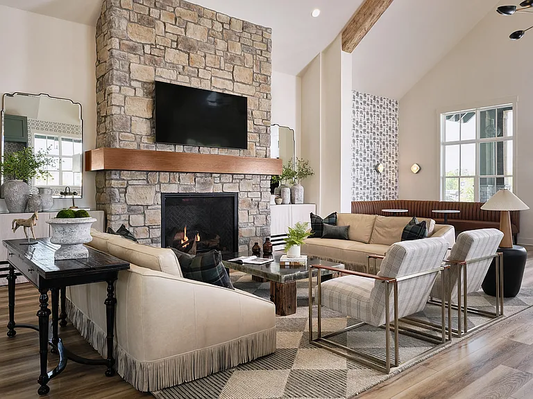 Clubhouse living room with ample seating, fireplace and TV.