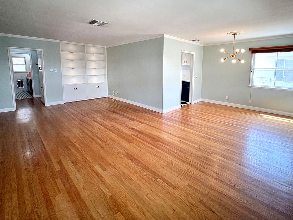 Living and dining rooms as viewed when entering the front door. Built in bookcase with recessed lighting.