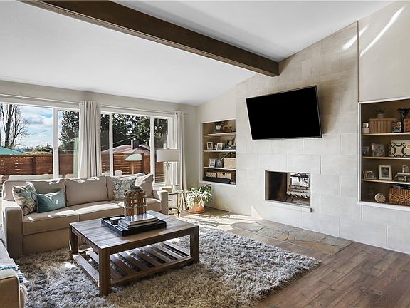 Living room features fireplace and built in book shelves.