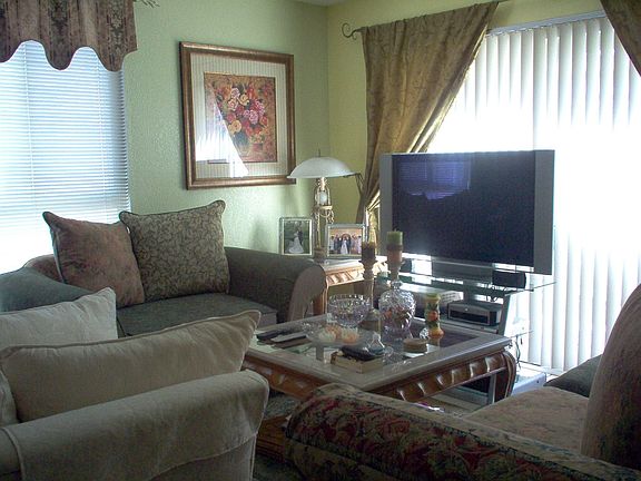 Family room with fireplace opens to backyard.