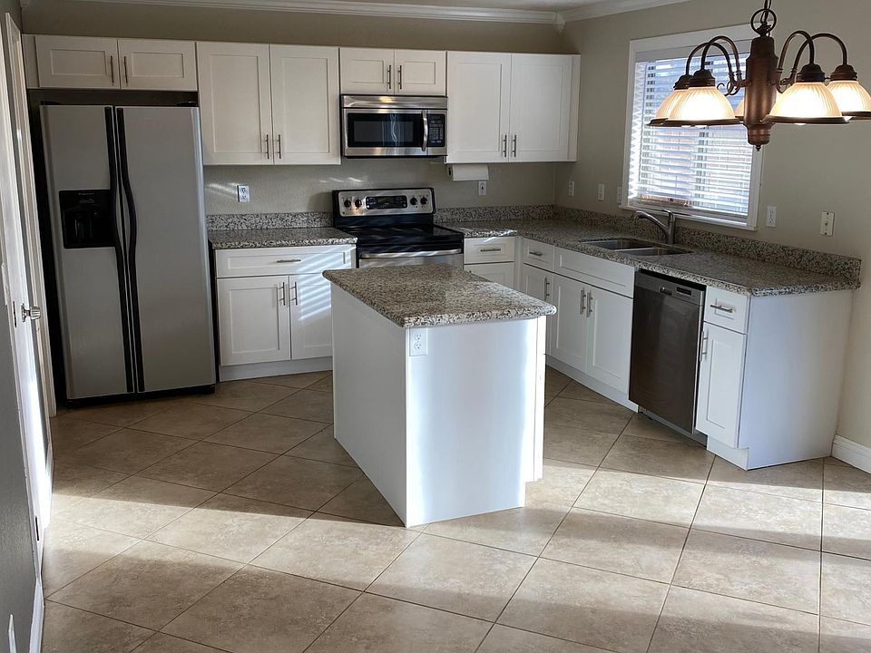 Newly updated kitchen with Shaker cabinets and granite countertops.