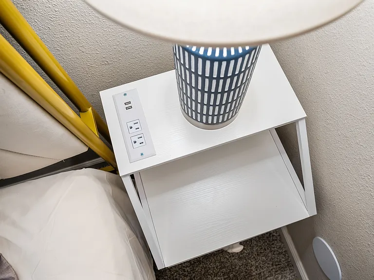 Easily charge your devices with an outlet near the bed.