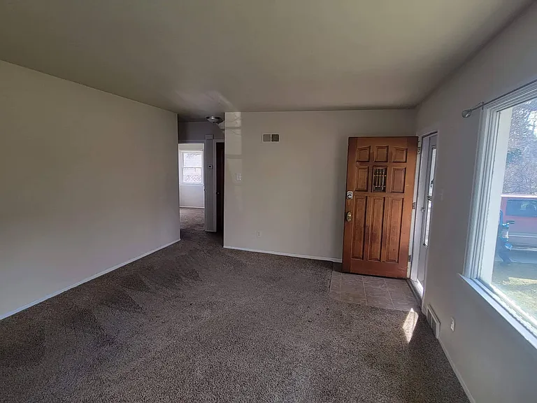 Living room from opposite corner - entrance to bathroom and bedrooms in far corner