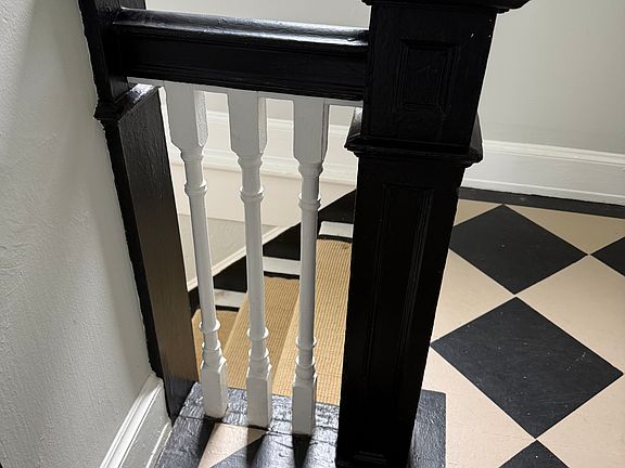 Painted harlequin floors on second floor hallway.
