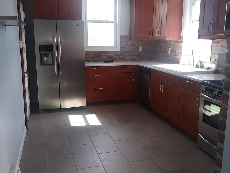 Renovated kitchen with SS appliances. (Refrigerator,Dishwasher,Microwave and Stove) Tons of cabinet storage space Door that leads to the yard and small storage area.