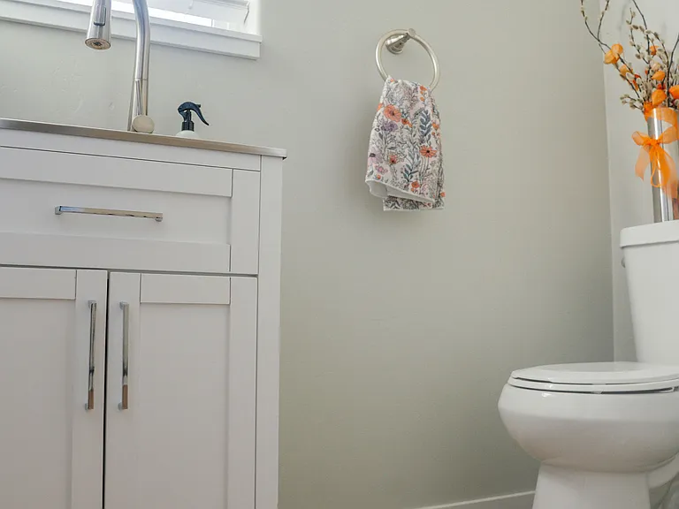 Half bathroom off of living room and kitchen