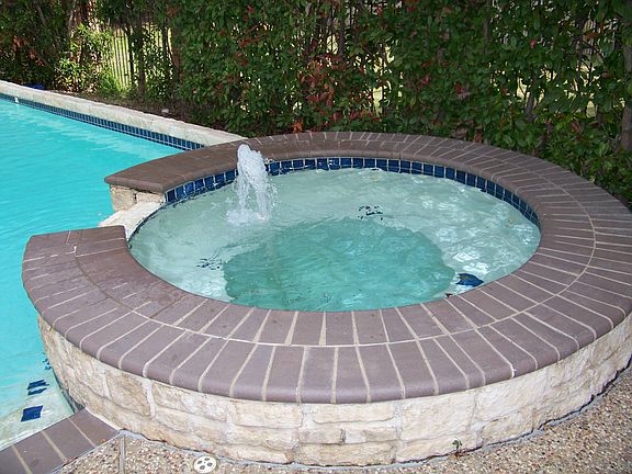 Spa built up with cascading water into pool