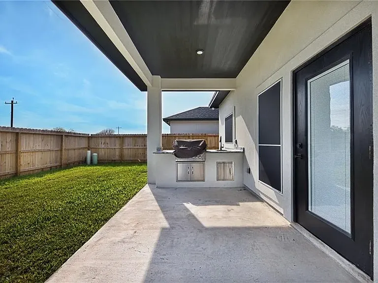 Enjoy outdoor living with a covered patio, built-in grill and sink. Perfect for weekend BBQ's and relaxing evenings.