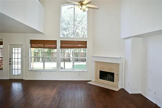 Great room with high ceiling and backyard view
