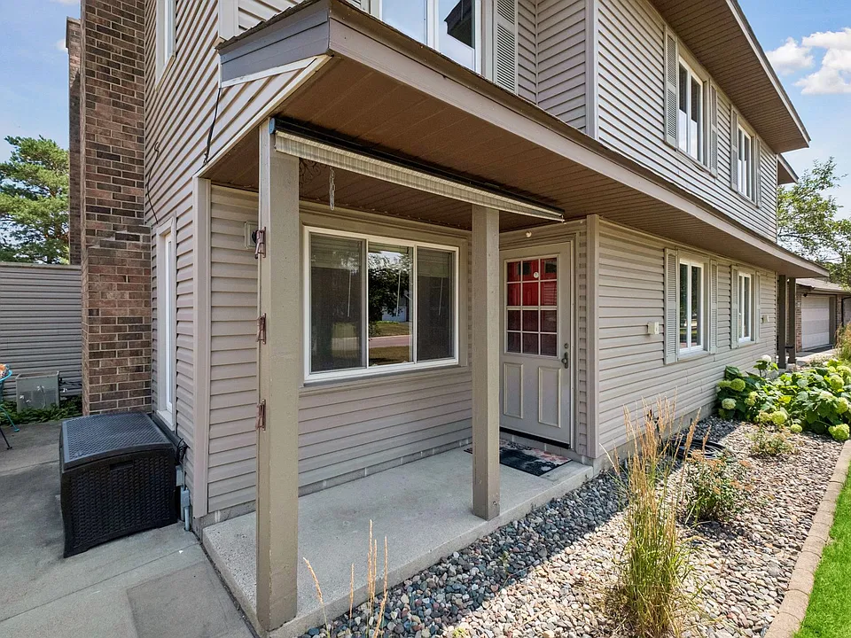 Private covered entry with well-maintained landscaping.