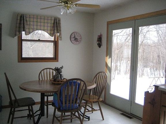 Spacious informal dining with full view french doors great for nature viewing.