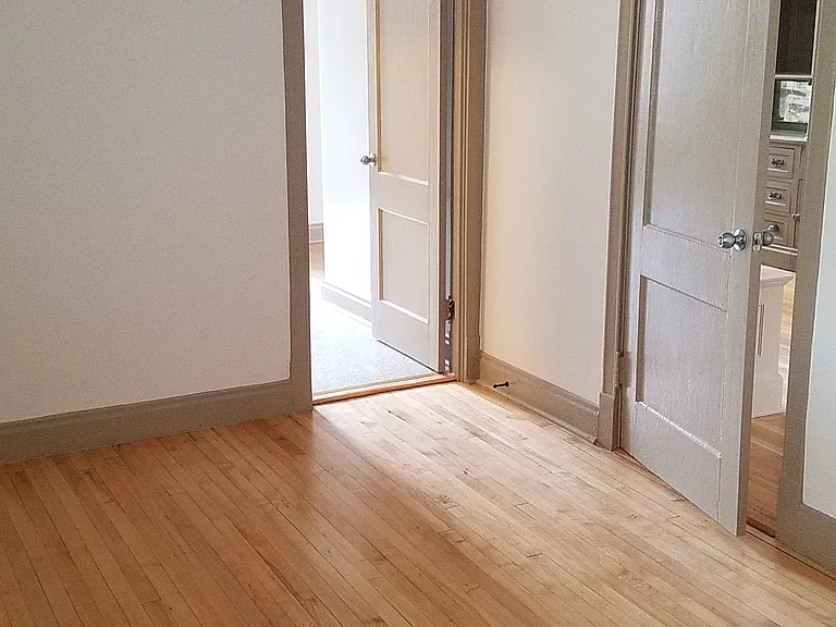 Bedroom from other angle. Door to kitchen/bathroom and door to living room from bedroom.
