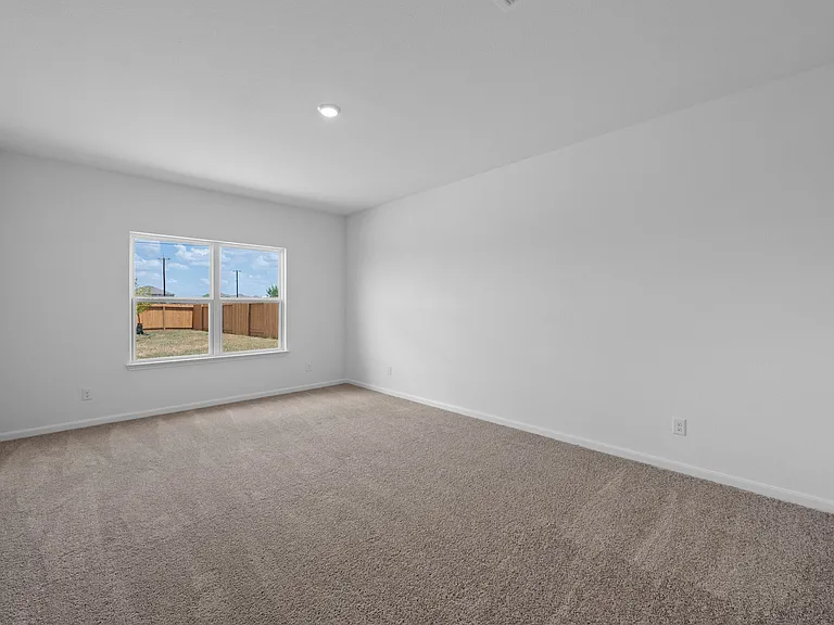 Downstairs master bedroom with carpet.