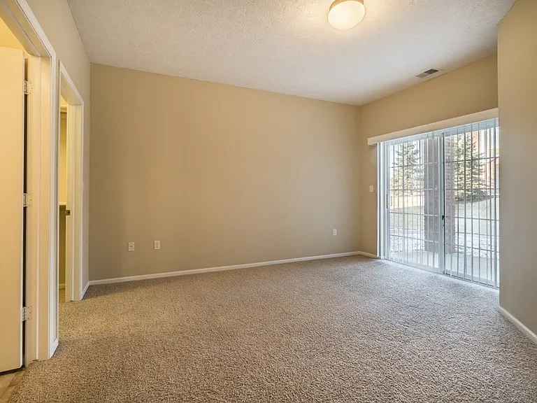 Some bedrooms feature sliding doors that open to a patio or balcony.