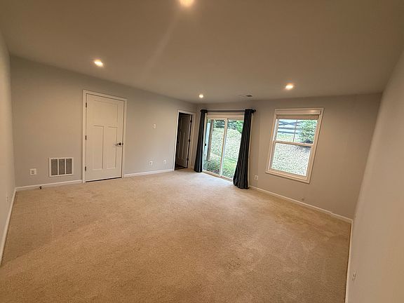 1st floor flex space, with sliding doors to backyard and attached full bathroom
