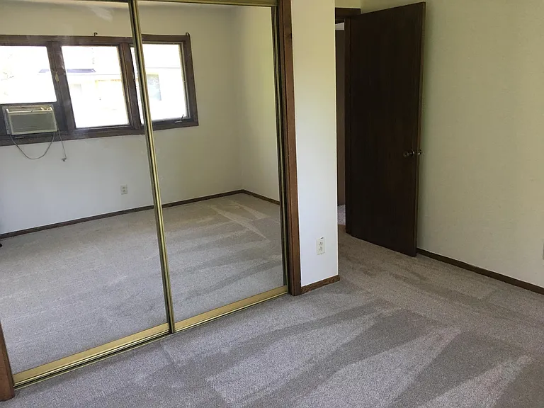 Large Master Bedroom with mirrored closet doors.