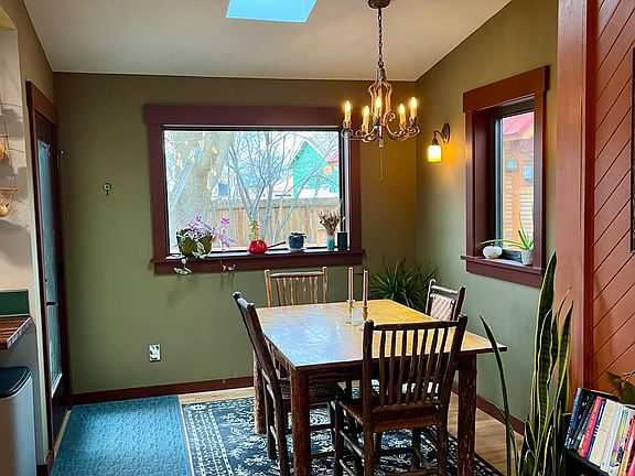 Eating area with large windows, skylight and full light door with South exposure