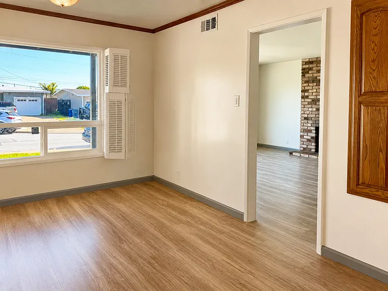 Kitchen and dining nook with bay windows in a quiet neighborhood with bright sunlit rooms.