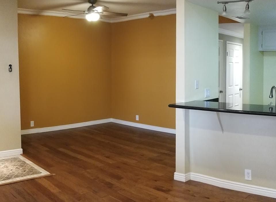 Front door, dining area, and kitchen