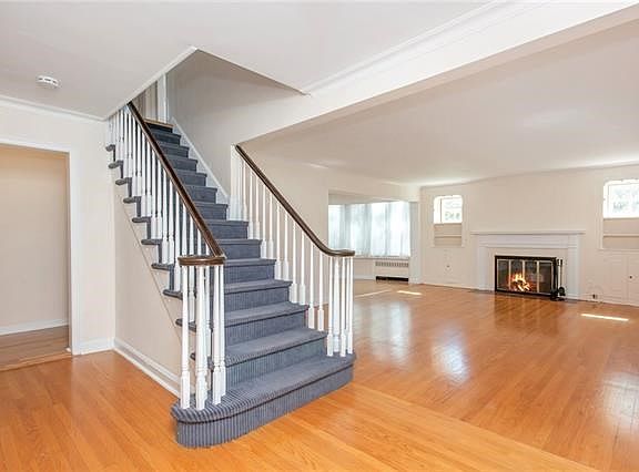 Open floor plan showing the living room with fireplace and partial view of dining room