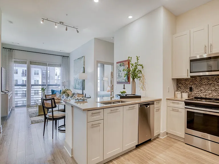 Stunning kitchens feature quartz countertops and tiled backsplash.