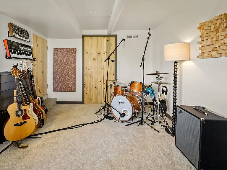 Storage space (with second freezer) behind large wood door