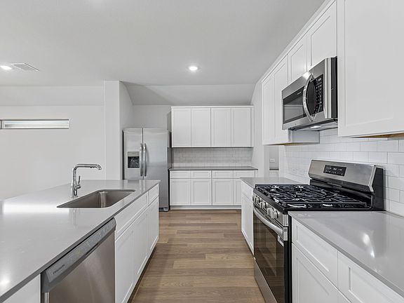 Kitchen in the Harrison home plan by Trophy Signature Homes - REPRESENTATIVE PHOTO