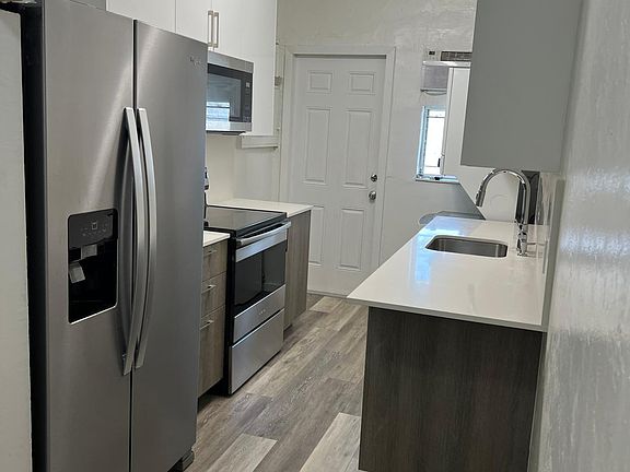 New Kitchen with new refrigerator new microwave. Rear door exit