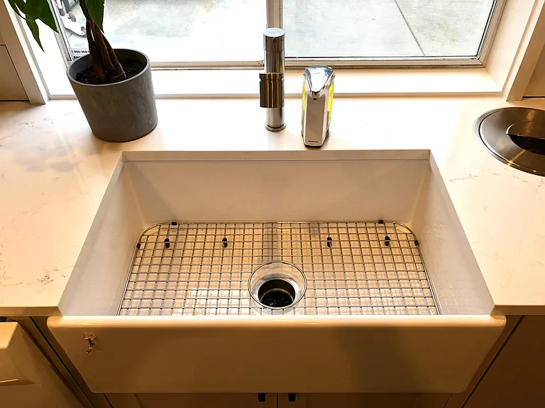 Large farm style sink with metal wire rack