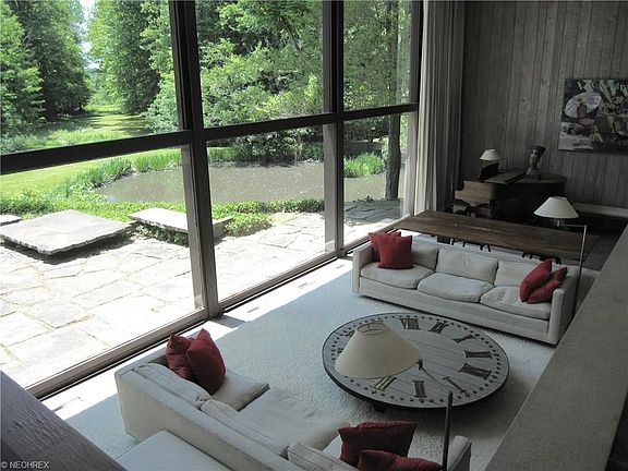 Two story wall of glass in the main living room looks out to the golf course fairway views which is 