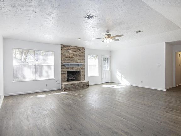 Living Room has lots of natural light, fireplace, and new paint and flooring.