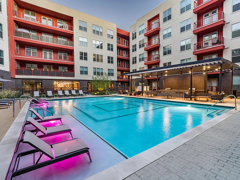 Enjoy the resort-style pool at Modera EaDo, featuring a spacious sunledge and serene water features for ultimate leisure.