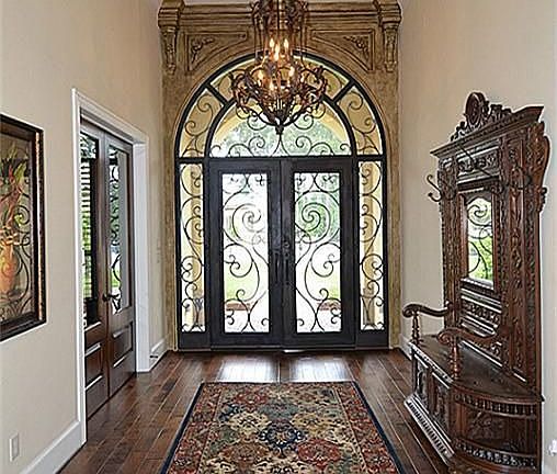 A true foyer with domed entry leads to an awesome view of the pool and water wall.