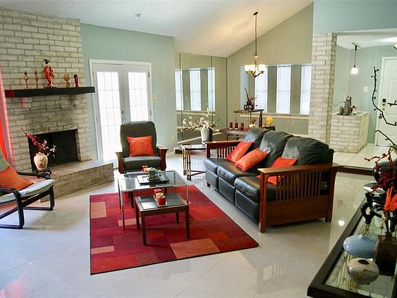 Open floorplan with large living room. High, vaulted ceilings with wood and tile flooring throughout.