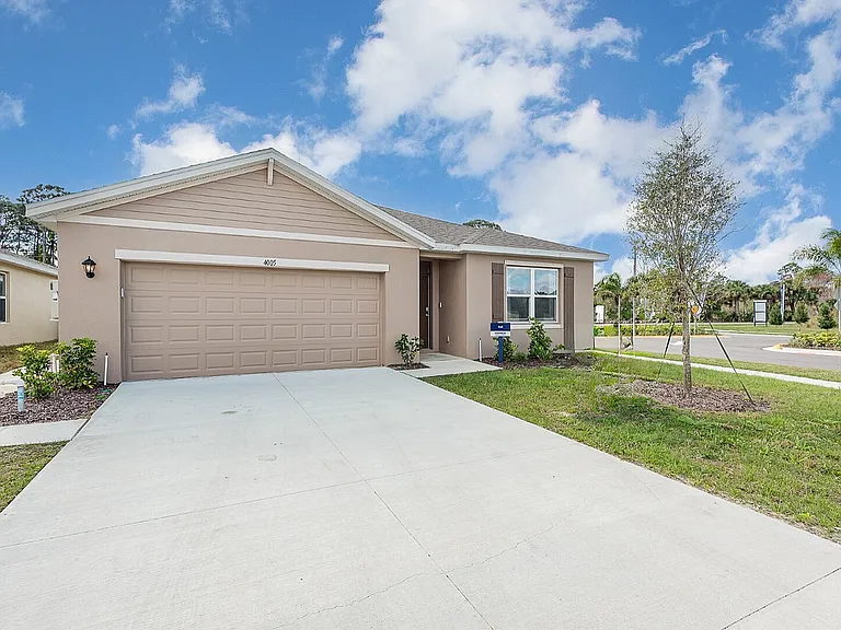 Charming suburban home with a sleek design, featuring a modern garage and manicured lawn.